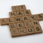 Drewniane płytki Scrabble układające się w napis It Has Always Been Thus
